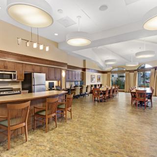 A modern kitchen and dining area with wooden furniture and appliances.