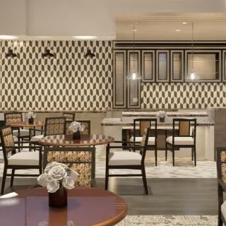 A modern restaurant interior featuring elegant decor and a cozy seating area.
