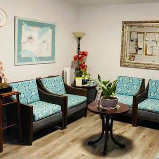 A cozy waiting room with comfortable chairs and decorative elements.
