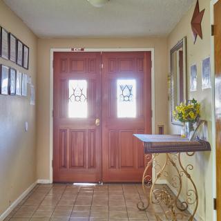 A welcoming entryway featuring wooden double doors and tasteful decor.