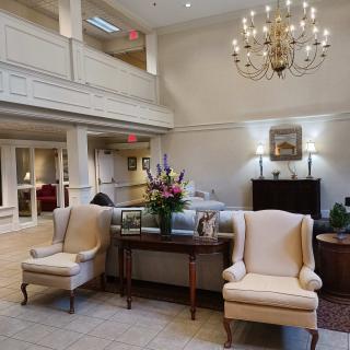 A luxurious lobby with elegant furniture and a chandelier.
