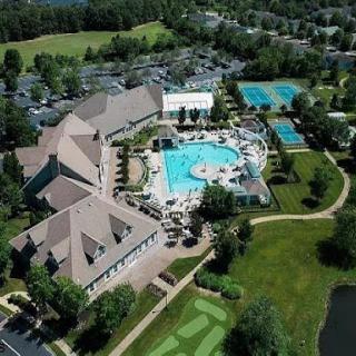 Aerial view of a resort featuring swimming pools and lush green landscapes.