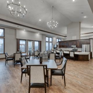 A modern dining area with elegant chandeliers and sleek furniture.