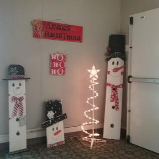 Festive holiday decorations featuring charming snowmen and a lit Christmas tree.