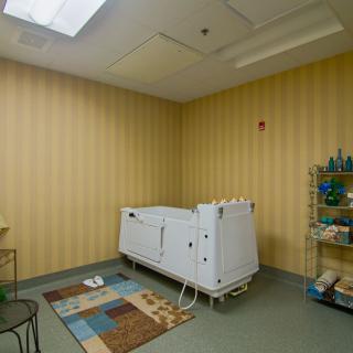 An interior view of a care facility bathroom with a specialized bathtub.