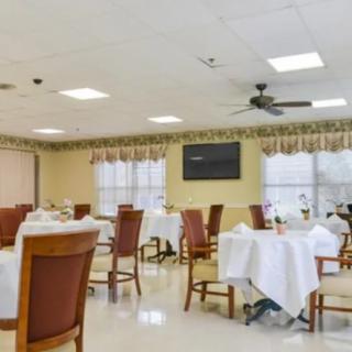 An empty dining room with neatly arranged tables and chairs.