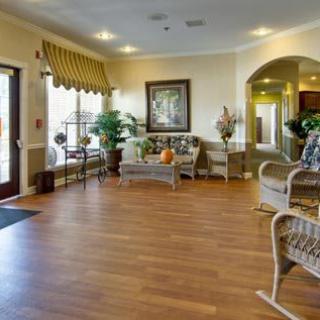 A welcoming lobby area with comfortable seating, decorative plants, and artwork on the walls.