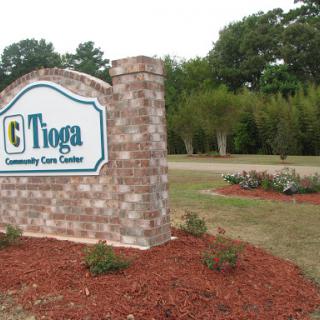 Signage for Tioga Community Care Center, showcasing the entrance with landscaped surroundings.