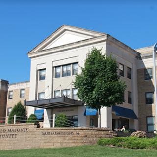 A modern building with a welcoming entrance under a clear blue sky.