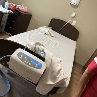 A view of a patient room with a hospital bed and medical equipment.