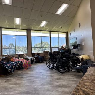 A spacious waiting area with multiple wheelchairs and large windows letting in natural light.