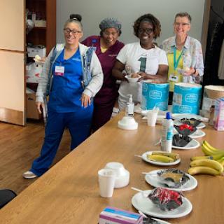 Team members enjoying a break with snacks at the workplace.