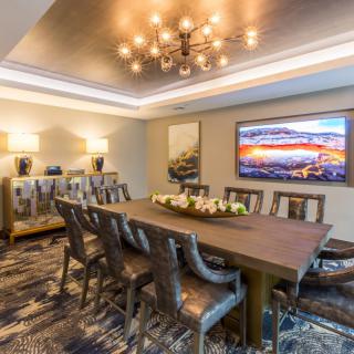 A modern dining room with elegant lighting and art on the walls.
