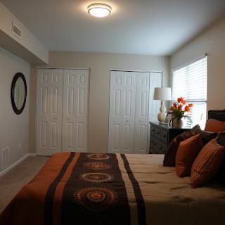 A cozy and elegantly decorated bedroom featuring a comfortable bed and stylish furnishings.