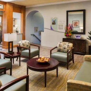 A comfortable waiting room with chairs and a coffee table.