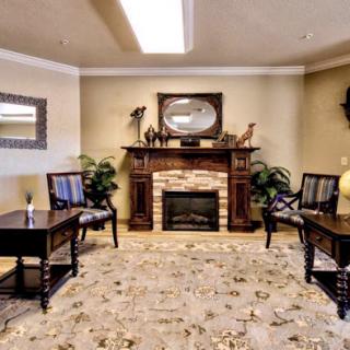 A cozy living room featuring a stylish fireplace, comfortable seating, and decorative elements.