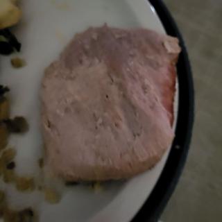 A piece of cooked meat on a plate.