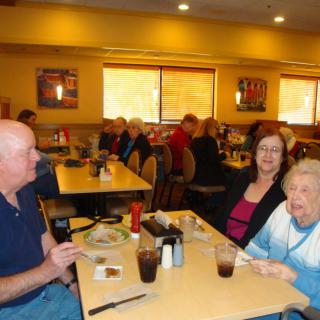 A group of people enjoying a meal together at a restaurant.
