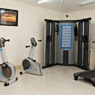 A well-equipped home gym featuring stationary bikes, a multigym machine, and a treadmill.