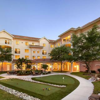 A well-maintained residential apartment complex with landscaped gardens and pathways.