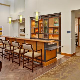 A modern bar area featuring elegant seating and ambient lighting.