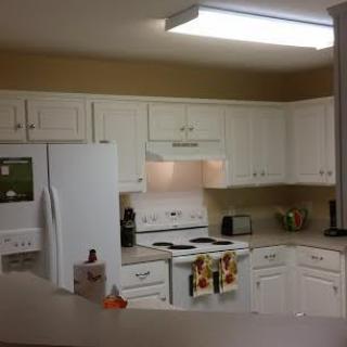 A modern kitchen with white cabinets and appliances.