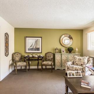 A cozy living room with elegant furniture and decorative elements.