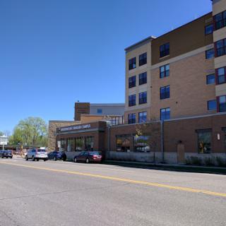 A modern hospital building captured on a clear day.
