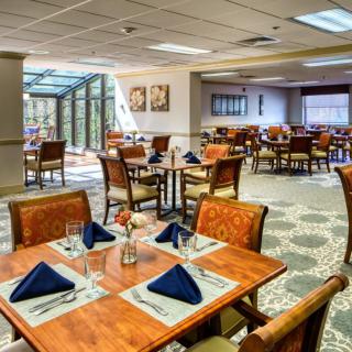 An elegant restaurant dining area with neatly arranged tables and chairs.