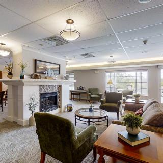 A cozy living room with modern decor featuring a fireplace and comfortable seating.