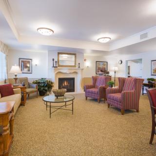 A cozy living room with comfortable seating and a warm fireplace.