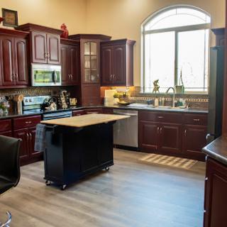 A beautifully designed modern kitchen featuring rich wooden cabinets and ample natural light.