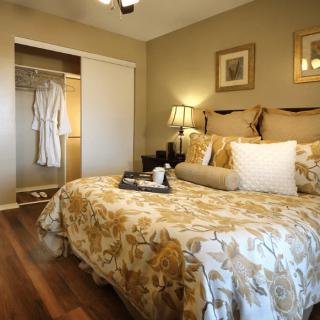 A cozy bedroom with elegant bedding and a warm ambiance.