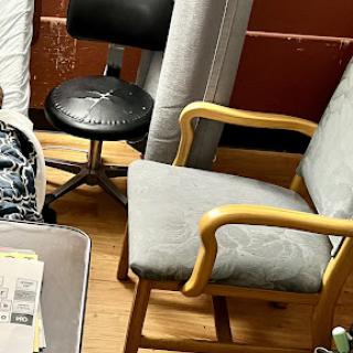 A cozy corner featuring different types of chairs in a room.