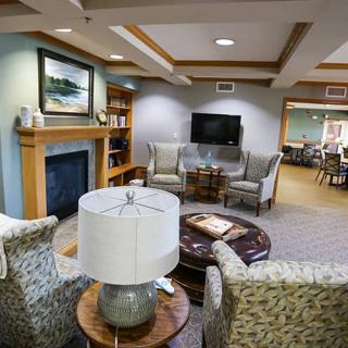 A cozy living room featuring a fireplace, comfortable seating, and a television.