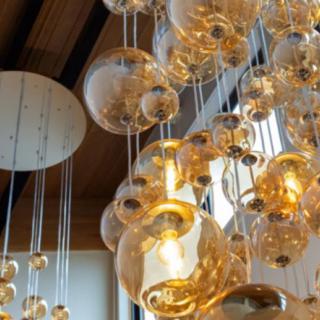 A modern chandelier with glass bubble lights creates a stylish and elegant ambiance.