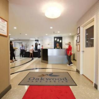 A hotel lobby with a reception desk and people present.