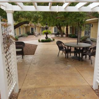 A serene courtyard with outdoor seating and lush greenery.