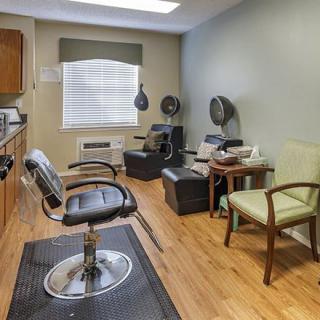 A cozy hair salon interior with styling chairs and equipment.