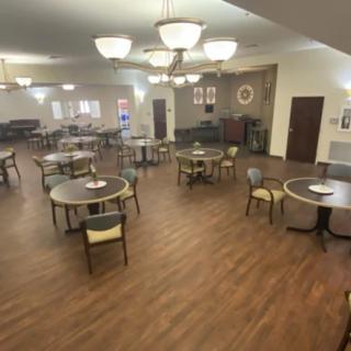 Spacious dining area with multiple tables and warm lighting.