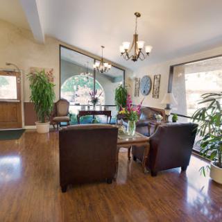 A welcoming and bright lobby space featuring comfortable seating, plants, and elegant decor.