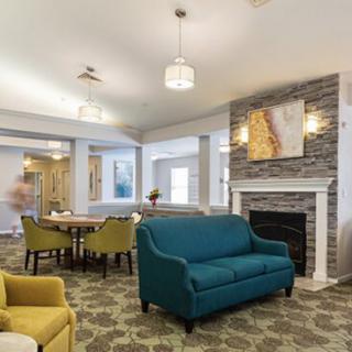 A modern living room with a cozy fireplace, vibrant furniture, and elegant lighting.