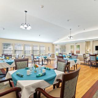 Spacious dining area with neatly set tables and elegant lighting.