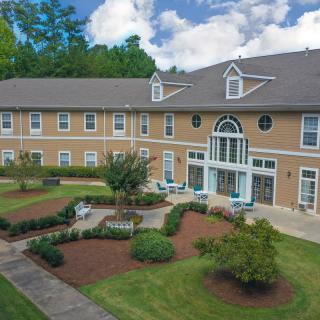 A residential building with a well-maintained garden and outdoor seating area.