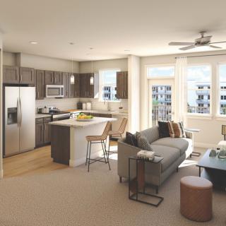 A modern apartment with an open floor plan featuring a living room and kitchen space.