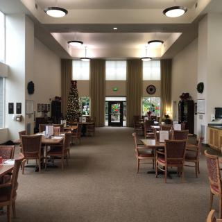 A quiet library interior with tables and chairs arranged for reading and studying.