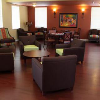 A cozy lounge area with modern furniture and warm lighting.