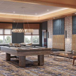 A stylish games room featuring a pool table and modern lighting.