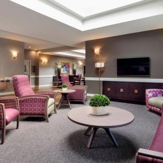 A modern lounge area with comfortable seating and a television.