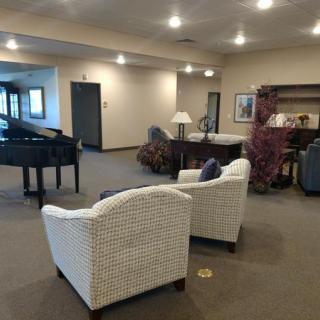 Spacious lobby with comfortable seating and a piano.